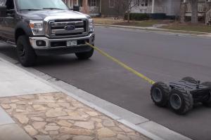 Stealth Super Mega Bot Towing a Ford F-250 Truck